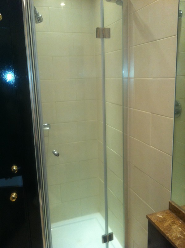 Frameless glass shower enclosure with chrome fittings in Leyton