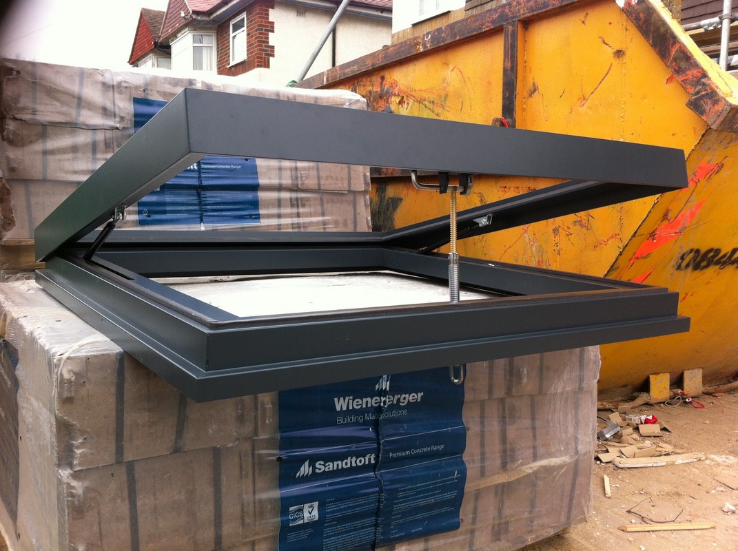Opening flat roof skylight in anthracite grey installed in Leyton