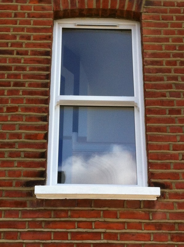 uPVC sash window on Victorian red brick house in Leyton